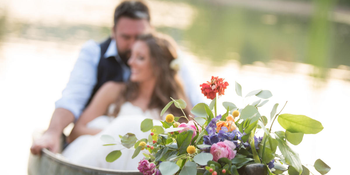 Bride, Groom and flowers in a boat